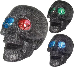 Teschio con luce negli occhi in colori assortiti 14 cm